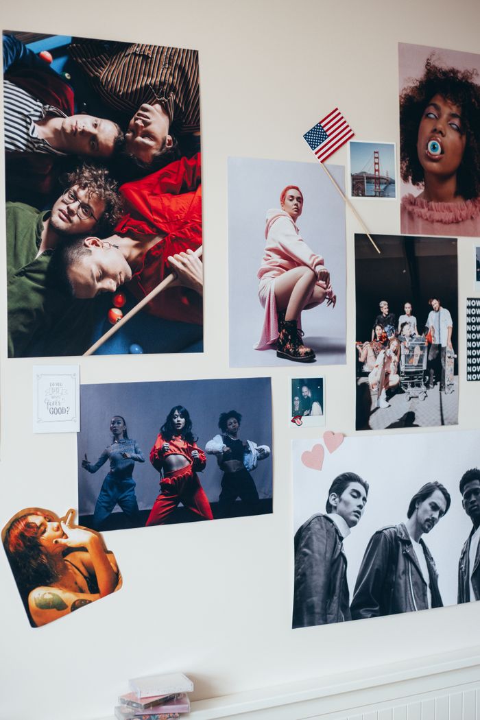 Creative wall collage featuring vibrant posters and diverse portraits. Perfect for modern decor inspiration.