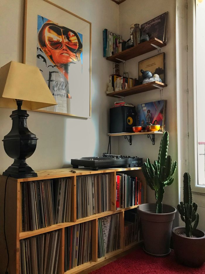 A cozy corner in a Paris apartment featuring vinyl records, cacti, and stylish decor.